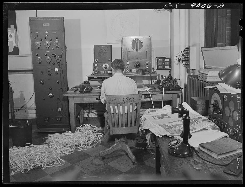Operator listening to broadcasts in the radio room of The New York Times.